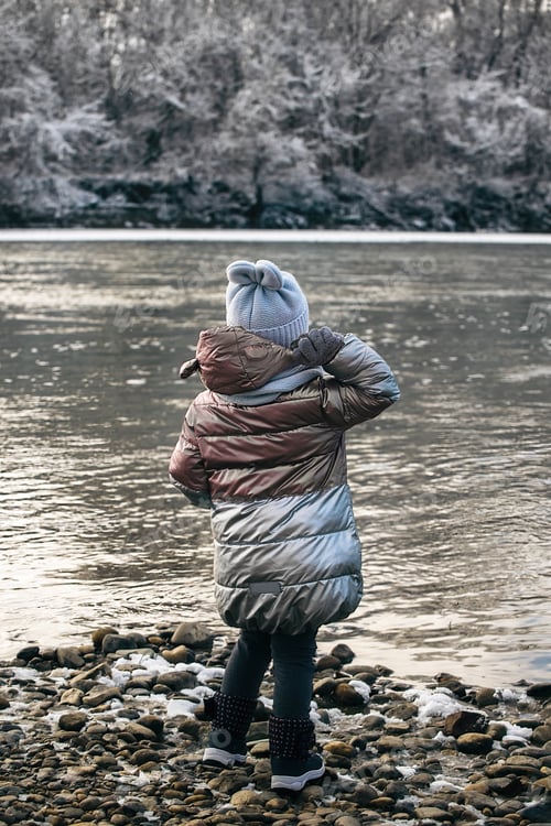 Preview: Children in the winter on a walk near the river