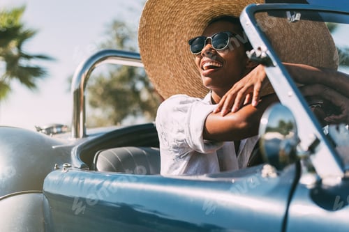 Preview: Black woman driving a vintage convertible car