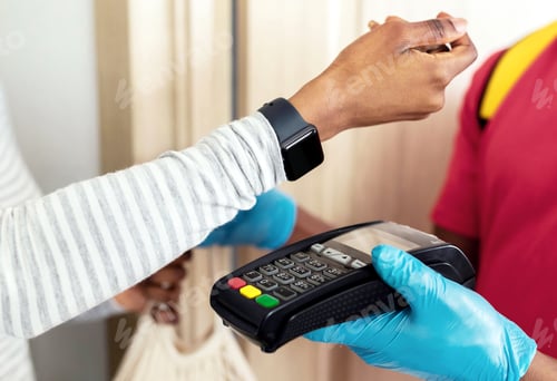 Preview: African Female Paying Supermarket Courier Using Smartwatch Indoor, Cropped