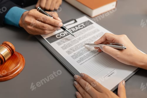 Preview: A male lawyer in a suit discusses contract details with a female client