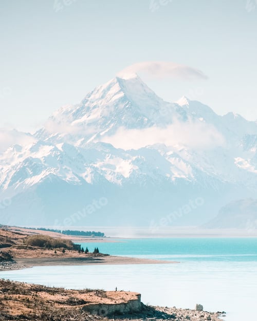 Preview: Vertical shot of a mountain range with a lake at the bottom in New Zealand on a sunny day