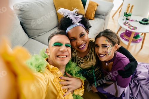 Preview: Multiracial group of friends taking selfie and having fun during Mardi Gras carnival.
