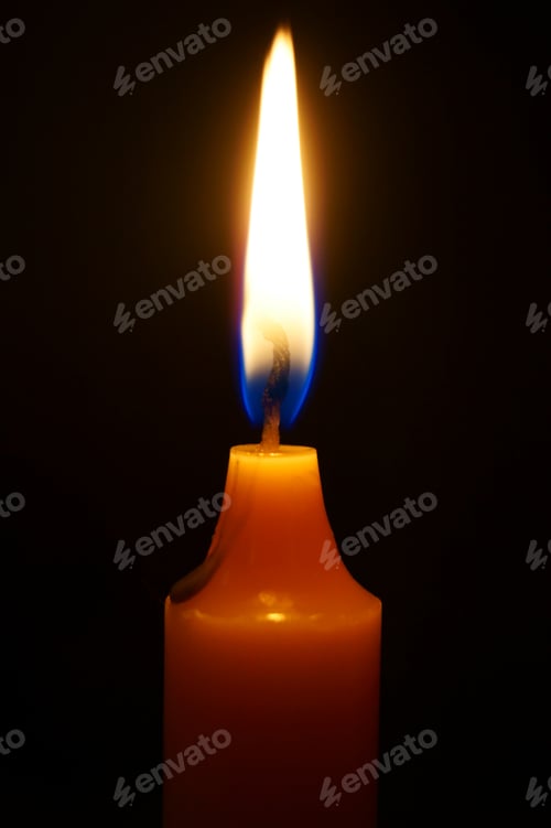 Preview: Burning candle on black background.