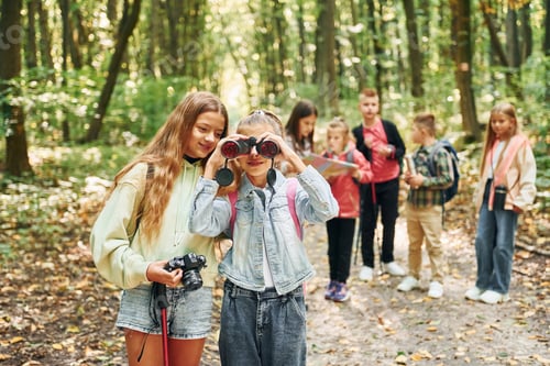 Preview: Conception of tourism. Kids in green forest at summer daytime together