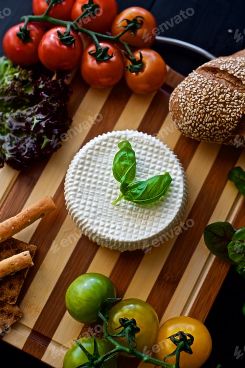 Preview: Flat lay of a healthy homemade cheese laying on the wooden board