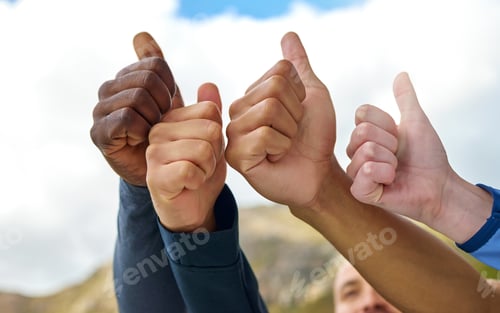 Preview: Closeup shot of a group of unrecognisable people showing thumbs up while exercising outdoors