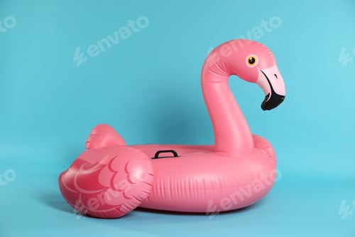 Preview: Inflatable flamingo shaped ring on light blue background