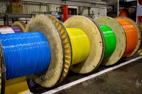Preview: Group of fiber optic cable reels with intertwined optical fibers