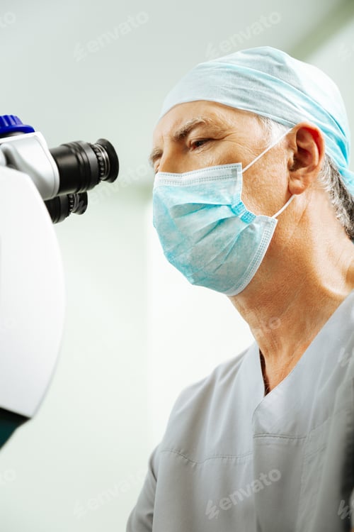Preview: Nice experienced eye doctor being at work