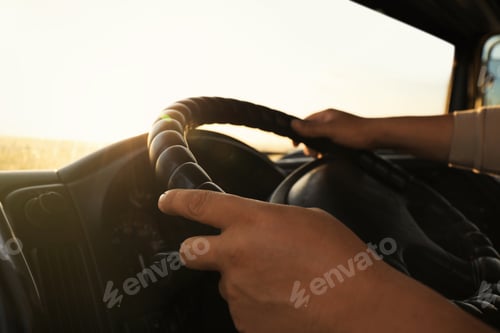 Preview: Man driving modern truck on sunny day, closeup