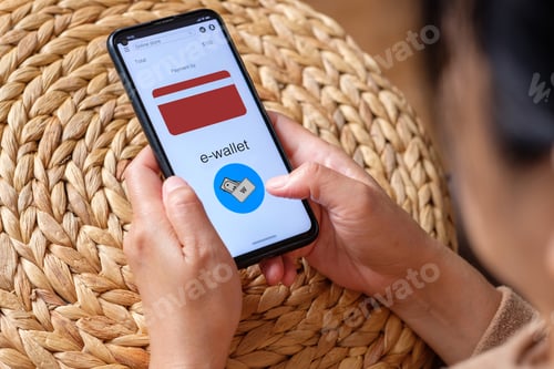 Preview: close up woman choose payment online on shopping mobile app on sofa at home