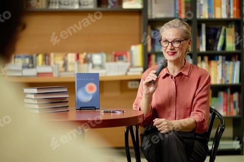 Preview: Caucasian Senior Woman Speaking into Microphone during Book Presentation