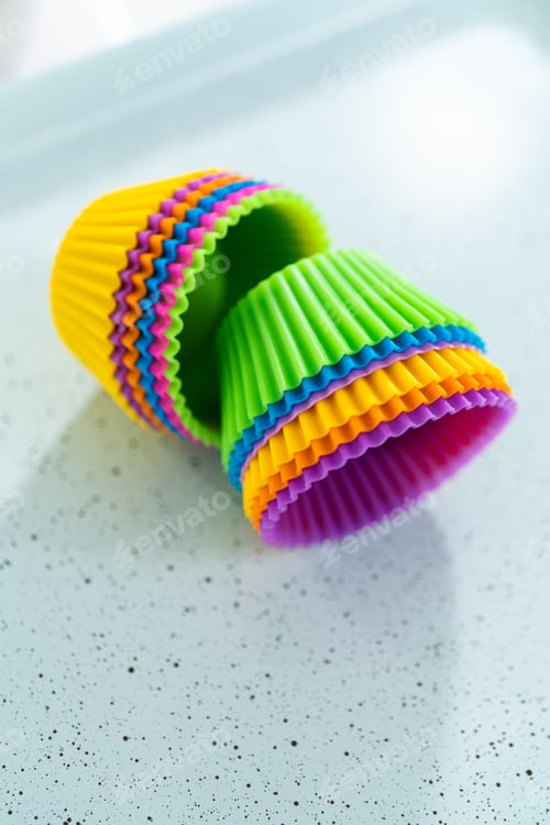 Preview: Colorful Cupcake Liners Stacked on a Light Surface