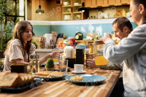 Preview: Family enjoying a weekend breakfast together in a sunny kitchen