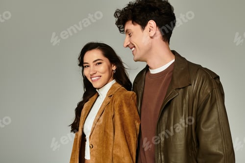 Preview: Stylish young couple enjoying a fun moment while showcasing modern fashion trends