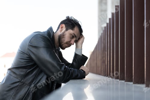 Preview: portrait of an adult man suffering from migraine and depression