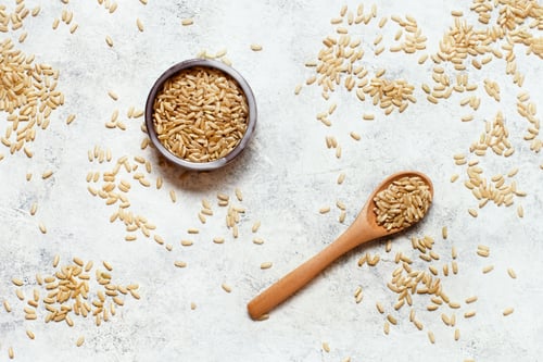 Preview: Brown rice in a wooden bowl with a spoon