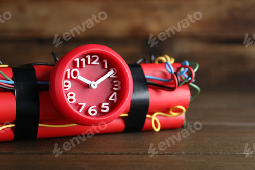 Preview: Dynamite time bomb on wooden table, closeup