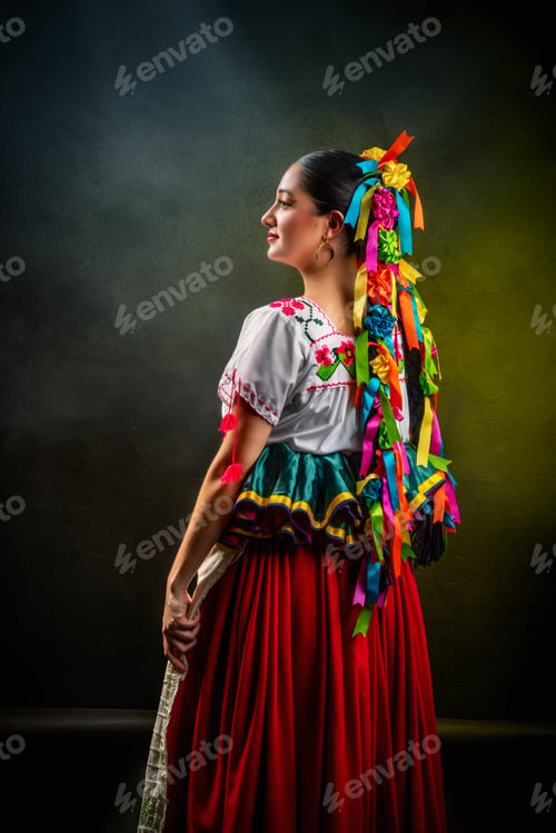Preview: A woman wearing a colorful dress and a headpiece with ribbons