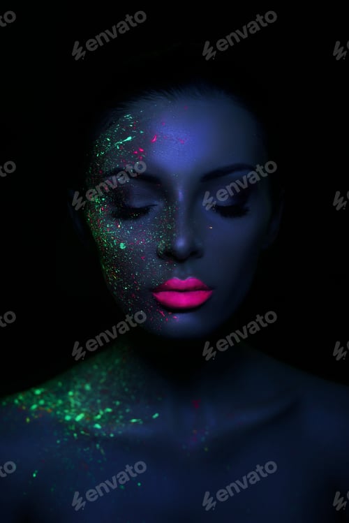 Preview: Fashion model woman in neon light bright fluorescent makeup, drop on face. Beautiful colorful makeup