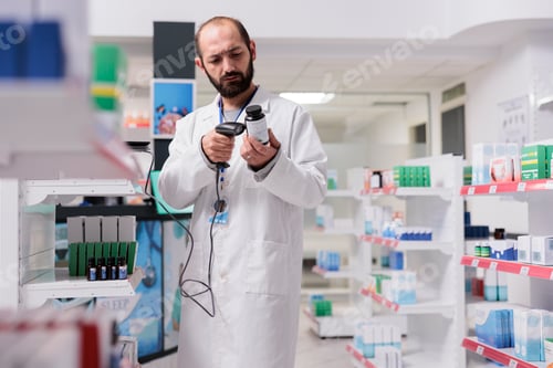 Preview: Caucasian pharmacist holding pills bottle scanning products bar code