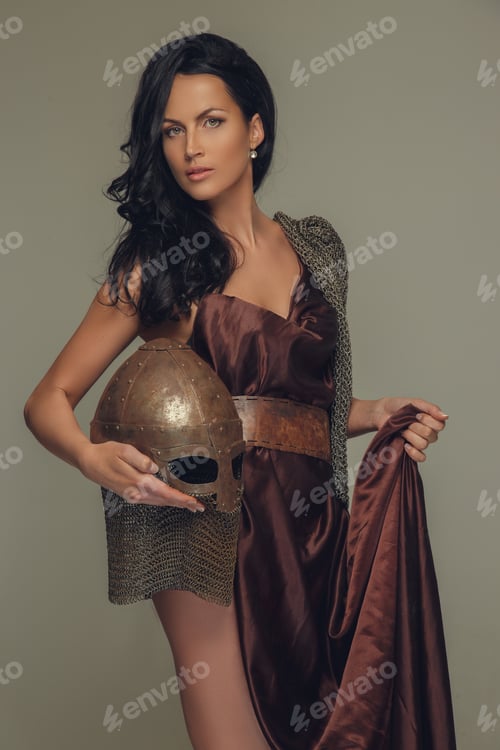 Preview: Portrait of brunette woman with encient helmet in her arm.