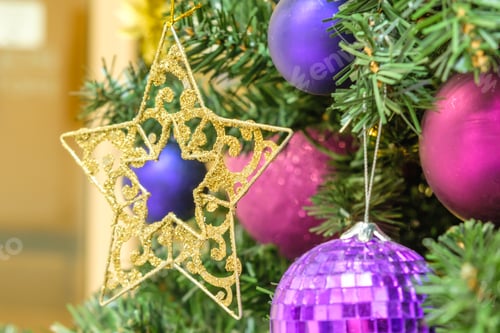 Preview: Gold star and garland lights, toys decoration on the Christmas tree on the background light bokeh