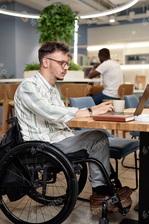 Preview: Man with disability working online