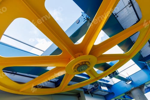 Preview: Wheel in a mechanism on a lift in a mountain forest against a cloudy sky