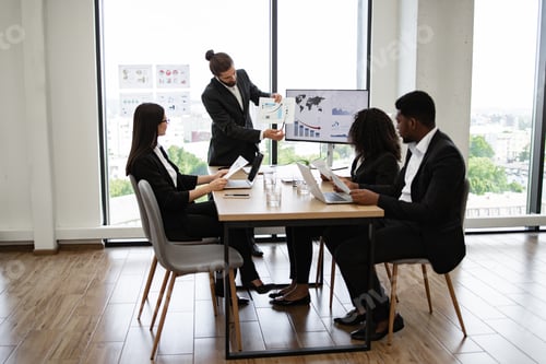 Preview: Business team in meeting discussing charts and graphs