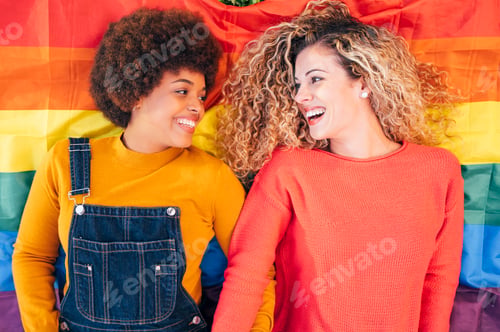 Preview: Two women friends hanging out in the city waving LGBT with pride flag