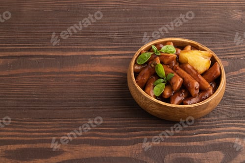 Preview: Tteokbokki or Topokki, fried rice cake stick, on brown wooden, side view, copy space