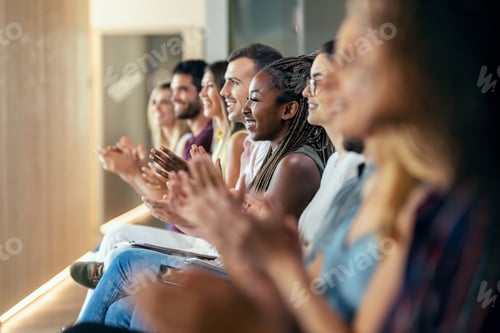 Preview: Happy business team clapping after listening the conference while sitting on coworking space.