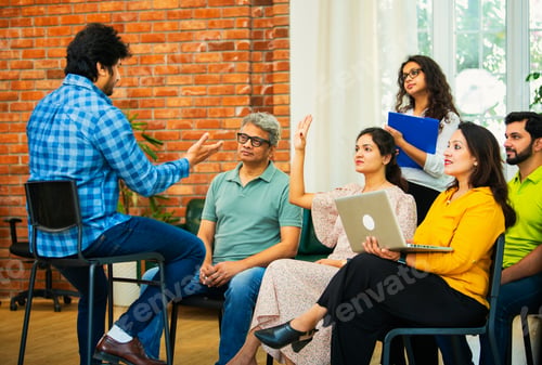 Preview: Indian Business manager guiding his team of young professionals in a cozy creative office setting
