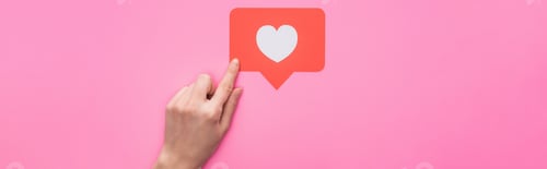 Preview: partial view of woman holding paper like sign isolated on pink, panoramic shot