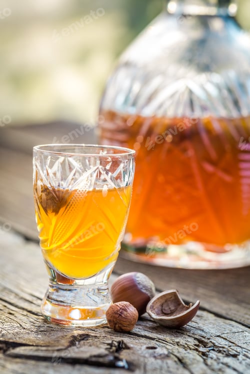 Preview: Tasty liqueur with nuts and alcohol on old wooden table