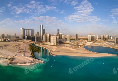 Preview: Aerial view on developing part of Al Reem island in Abu Dhabi on a cloudy day. Turquoise sea water.