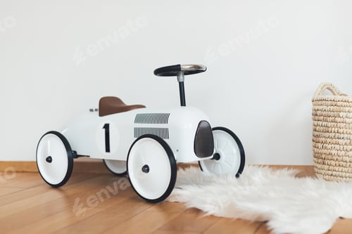 Preview: Retro style beige toy car in child room background. Stylish toy for toddler boy