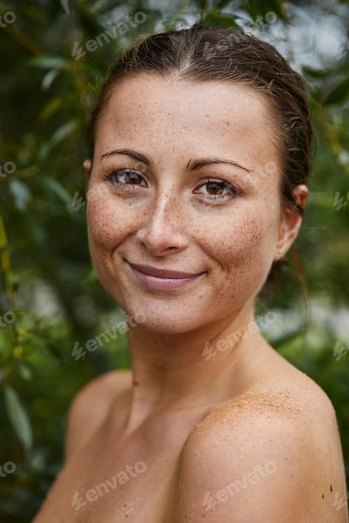 Preview: Portrait of freckled young woman in nature