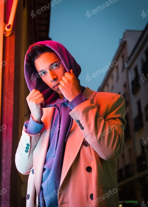 Preview: Young millennial hispanic man with red neon light reflection