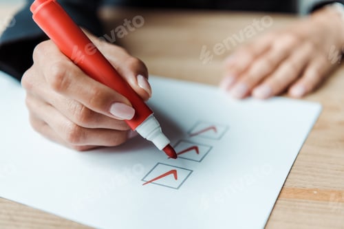 Preview: cropped view of woman putting check park in check list