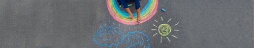 Preview: child draws with chalk on the pavement. Selective focus.