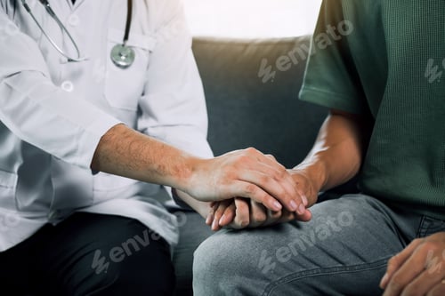 Preview: Doctor is holding the hand of the patient by giving him confidence in the doctor.