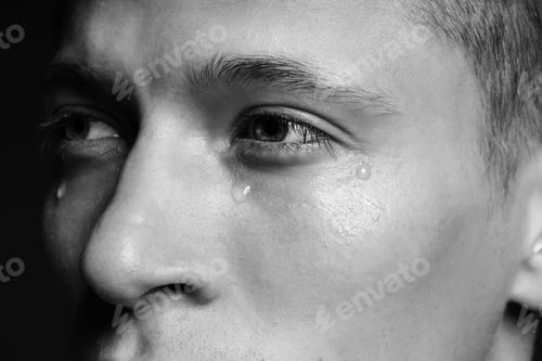 Preview: Sad man crying on dark background, closeup. Black and white effect