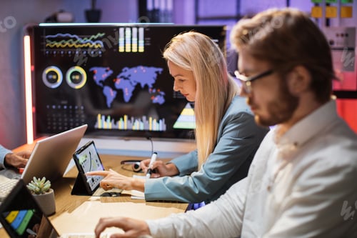 Preview: Caucasian financiers with modern gadgets studying charts