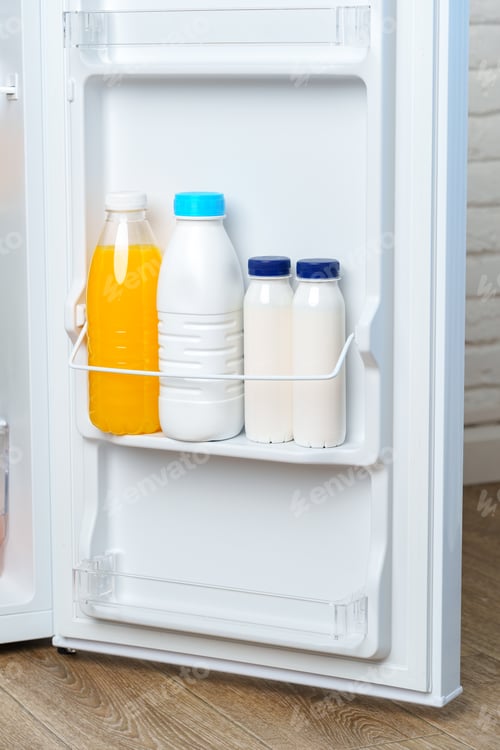 Preview: Open Refrigerator Door With Juice, Milk, and Fresh Produce
