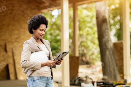 Preview: Black Woman Architect Using A Digital Tablet At Construction Site