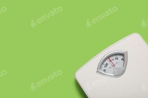 Preview: Bathroom scale on light green background, top view. Space for text