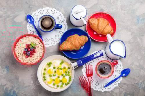 Preview: Traditional breakfast with eggs, oatmeal porridge, croissants and coffee