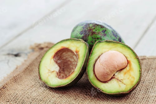 Preview: Fresh Avocado Cut on Burlap and Rustic Table
